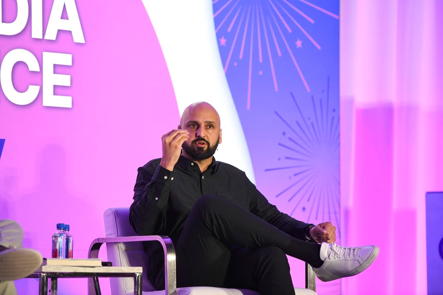 AJ Kumar speaking at a conference on personal branding and creator economics