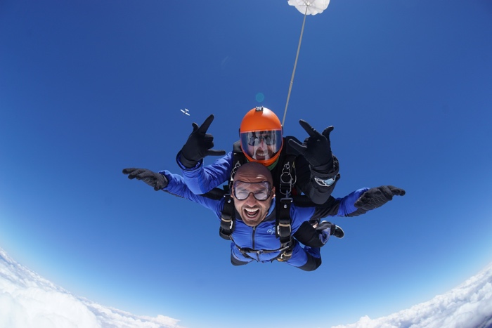 AJ Kumar's safely plummeting to earth via parachute.